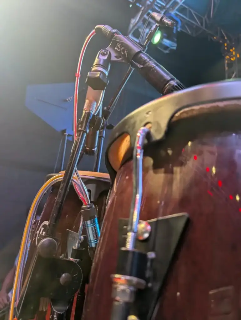Conga fitted with a clip-on microphone marked BCK on stage in Kenya