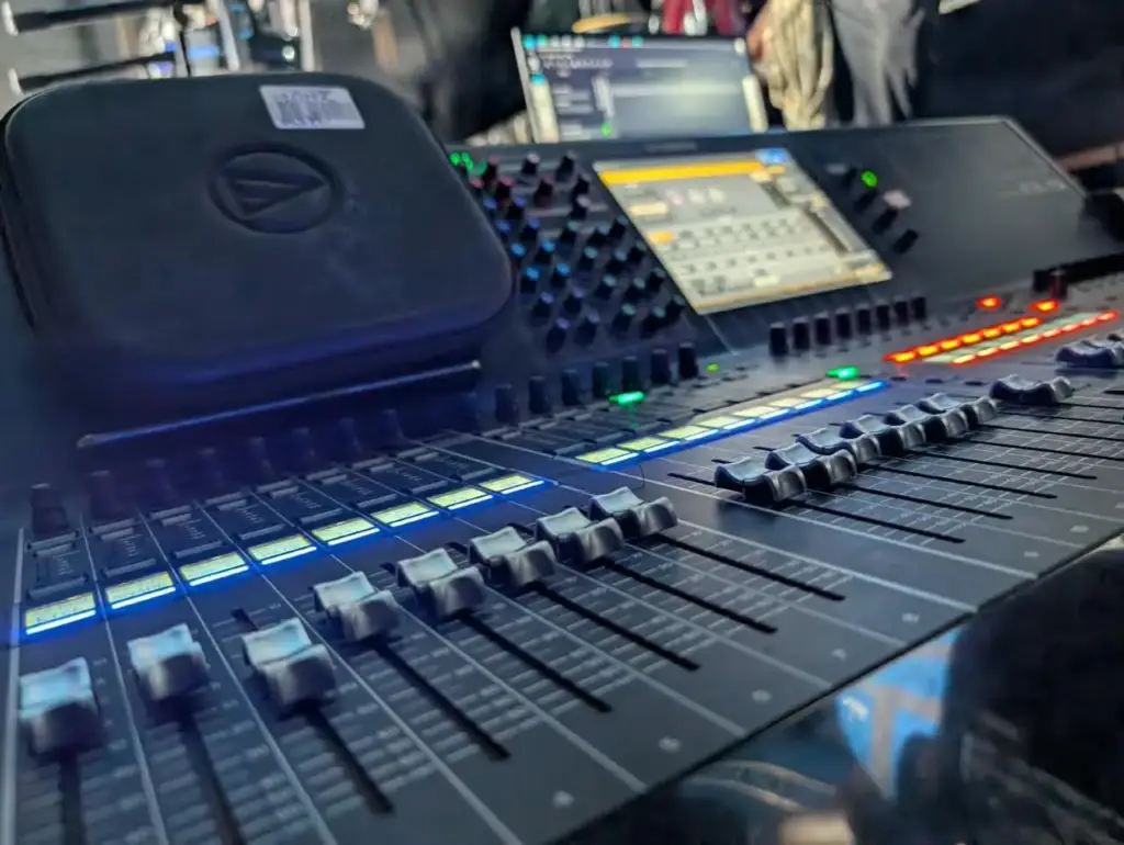 Digital mixing console with lit channel meters and faders in Kenya