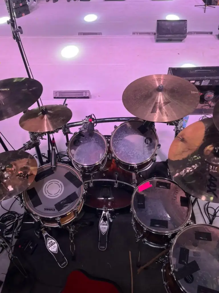 Drum kit seen from the drummer's seat, with Tama Iron Cobra pedals and Zildjian K and Sabian AAX cymbals, in Kenya