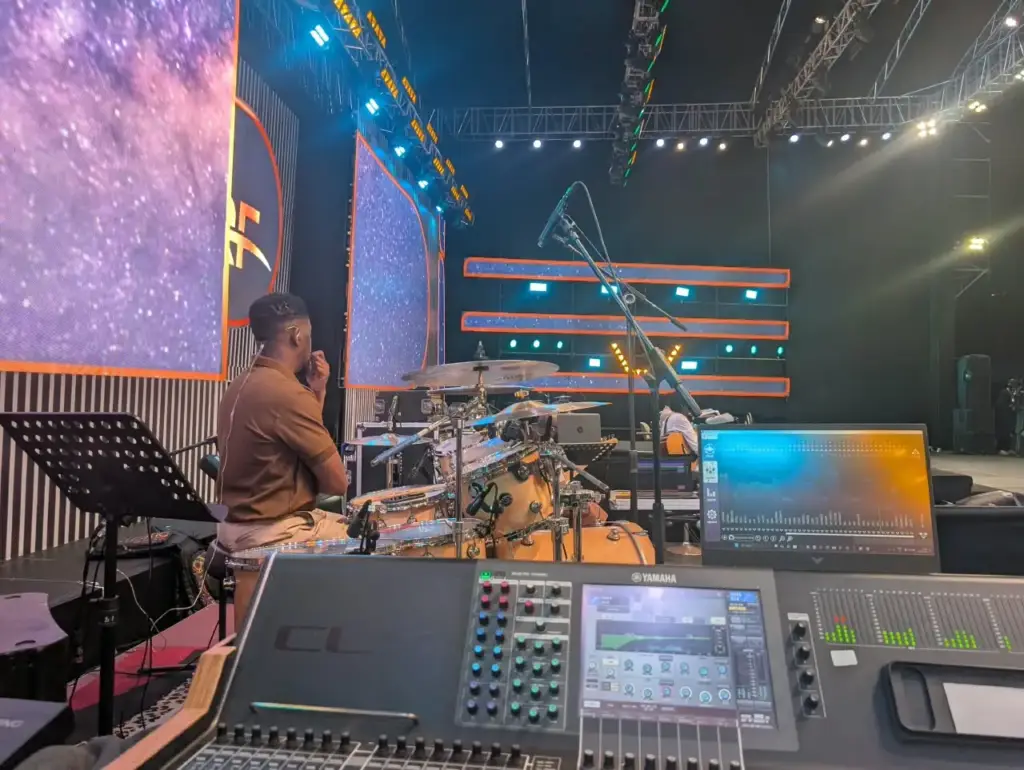 Drummer at the shared house drum kit in front of the LED walls, seen from the mixing position at Rhema Feast 2026, Nairobi