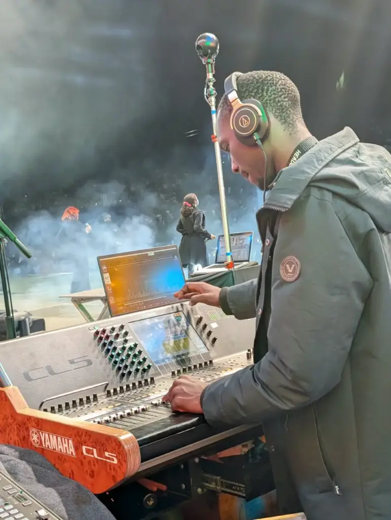 Backline Concepts engineer in Audio-Technica headphones building stage monitor mixes on a Yamaha CL5 during an evening session at Rhema Feast 2026, Uhuru Park Nairobi