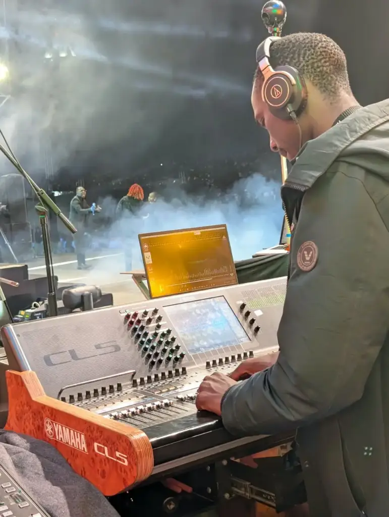 Backline Concepts engineer building stage monitor mixes on a Yamaha CL5, with the immersive in-ear display alongside, at Rhema Feast 2026 in Nairobi