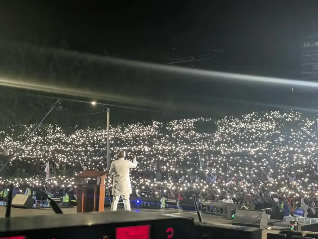 Wide view from the stage of the Rhema Feast 2026 evening congregation at Uhuru Park, Nairobi, lit by phone torches