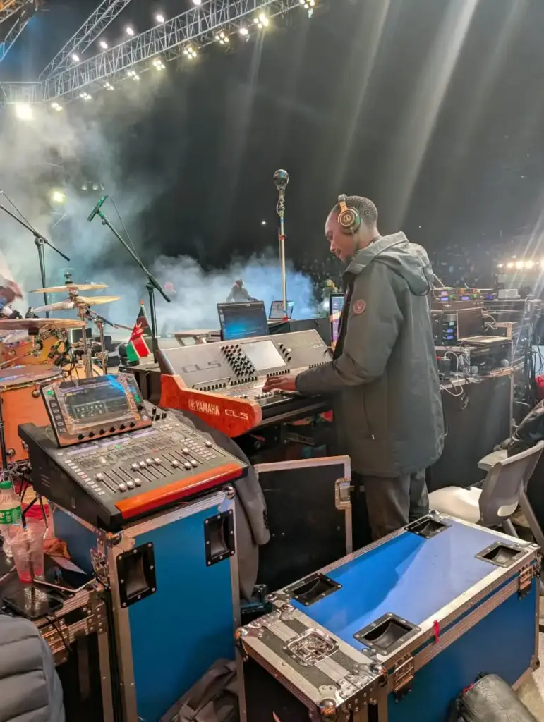 Stage mix position at Rhema Feast 2026 with a Yamaha CL5, a second compact console and open flight cases beside the stage in Nairobi