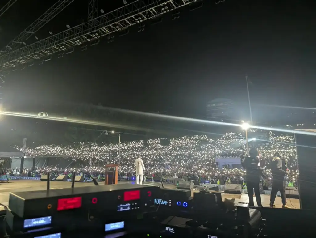 View past the monitor console across the stage to the Rhema Feast 2026 crowd at Uhuru Park, Nairobi