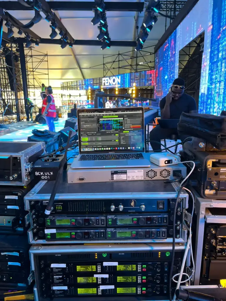 Backline Concepts Shure ULX-D wireless receiver rack, labelled BCK ULX 001, with wireless coordination software on a laptop in Kenya
